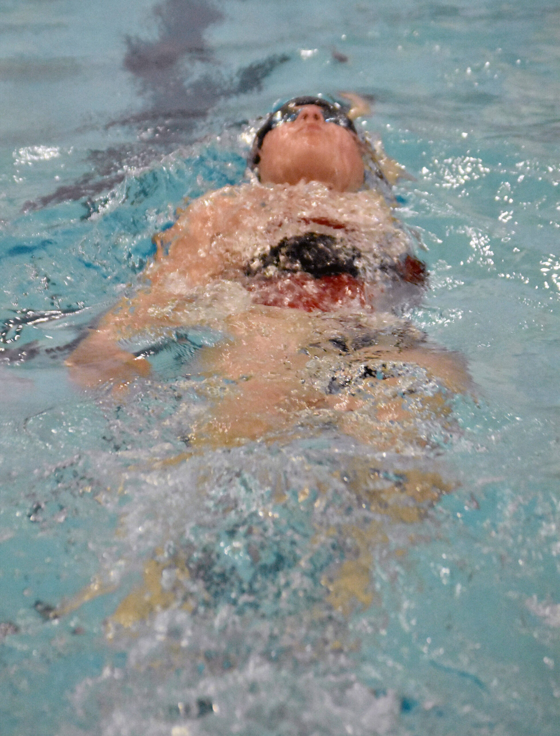 Kenai Central’s Abigail Price competes in the 100-yard individual medley in the SoHi Pentathlon on Friday, Oct. 11, 2024, at Soldotna High School in Soldotna, Alaska. (Photo by Jeff Helminiak/Peninsula Clarion)