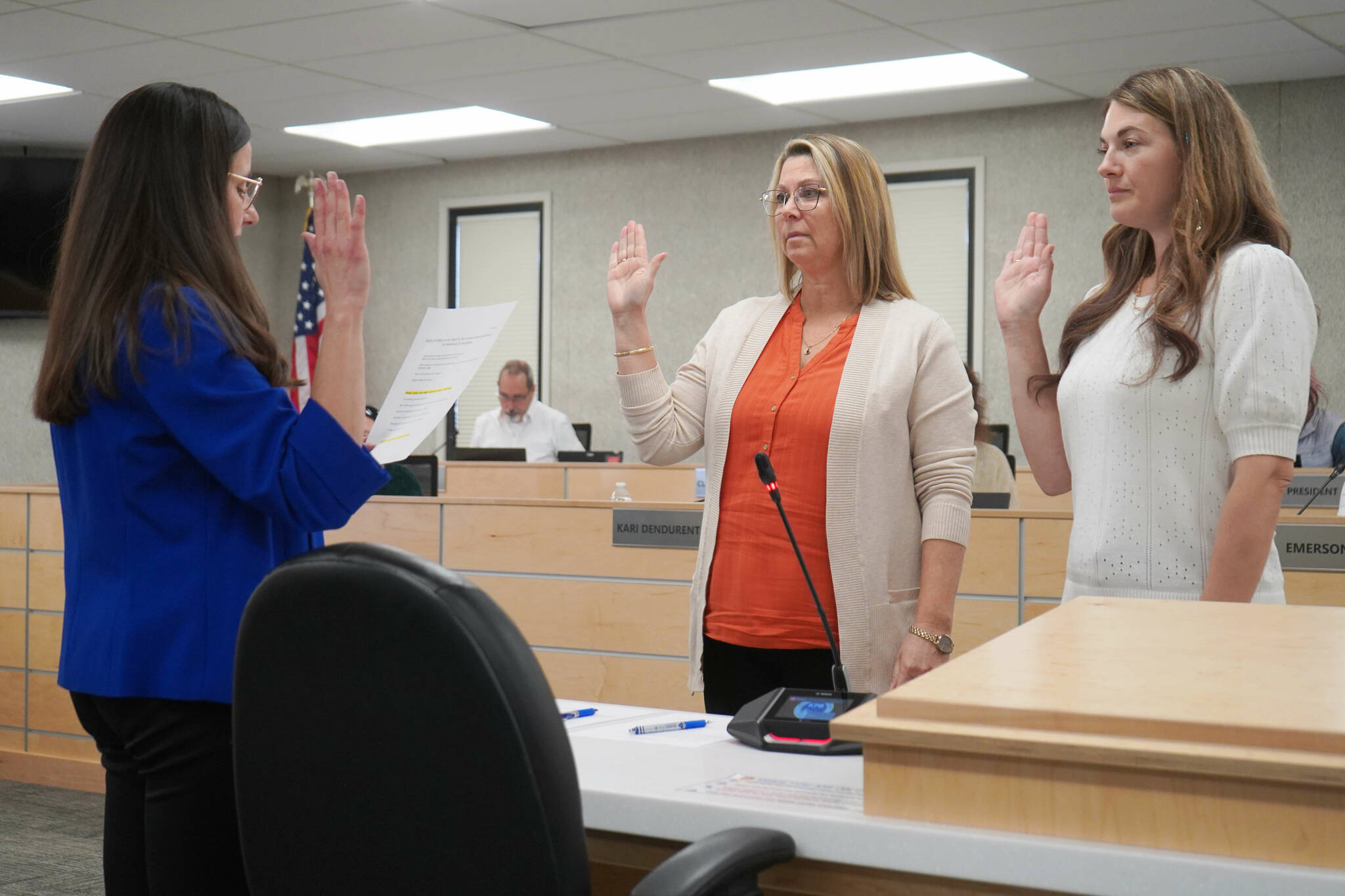 Administrative Secretary Nikkol Sipes administers oaths of office to Kenai Peninsula Borough School District Board of Education members Kelley Cizek and Sarah Douthit on Monday, Oct. 14, 2024. Cizek was reelected to represent Sterling and Funny River, Douthit was elected to represent Kenai during the Oct. 1 municipal election. (Jake Dye/Peninsula Clarion)