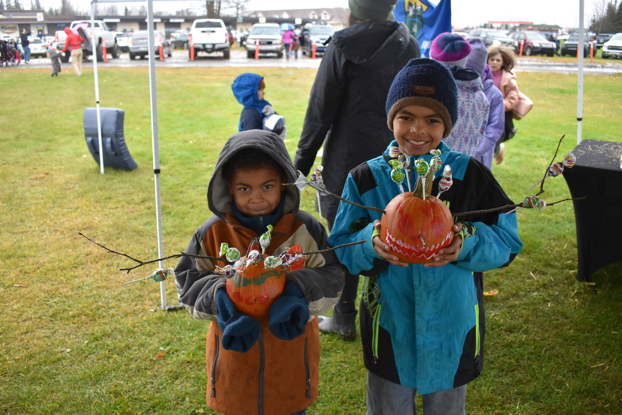 Two young contestants hold their pumpkins at the City of Kenai’s 9th annual Fall Pumpkin Festival in Kenai, Alaska, on Saturday, Oct. 12, 2024. (Photo by Jonas Oyoumick/Peninsula Clarion)