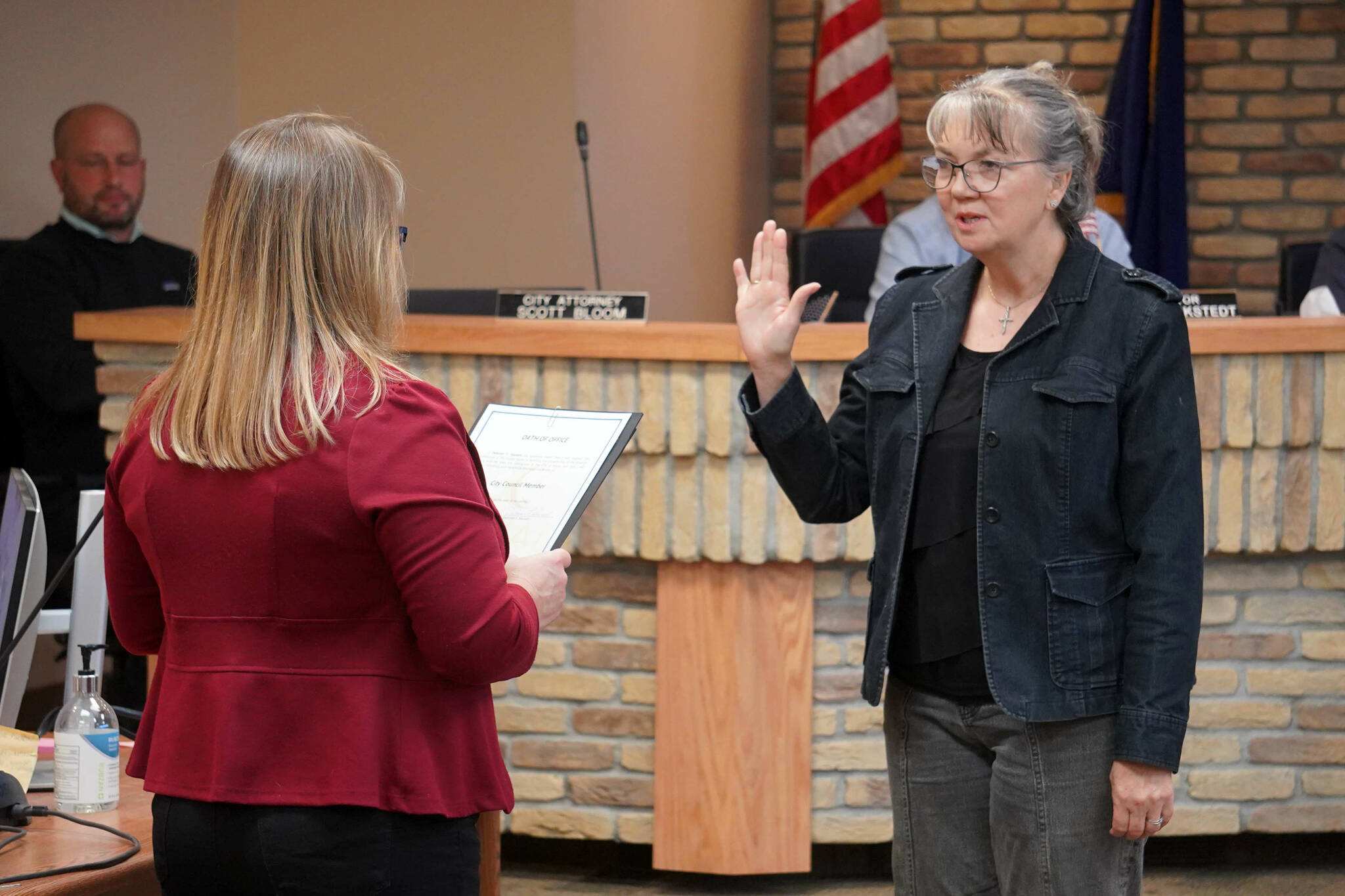 Kenai City Clerk Shelie Saner administers an oath of office to Deborah Sounart during a meeting of the Kenai City Council in Kenai, Alaska, on Wednesday, Oct. 16, 2024. Sounart won reelection to the council during the Oct. 1 municipal election. (Jake Dye/Peninsula Clarion)