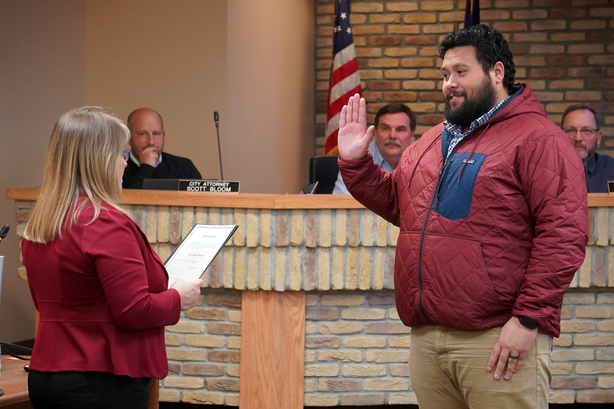 Kenai City Clerk Shelie Saner administers an oath of office to Sovala Kisena during a meeting of the Kenai City Council in Kenai, Alaska, on Wednesday, Oct. 16, 2024. Kisena won election to the council during the Oct. 1 municipal election. (Jake Dye/Peninsula Clarion)