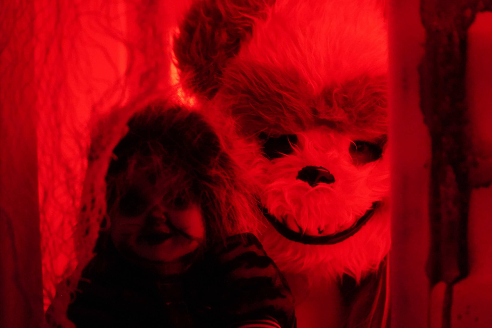 One frightening figure peers out from a doll house in the Haunted Chamber at the Kenai Chamber of Commerce and Visitor Center in Kenai, Alaska, on Friday, Oct. 18, 2024. (Jake Dye/Peninsula Clarion)