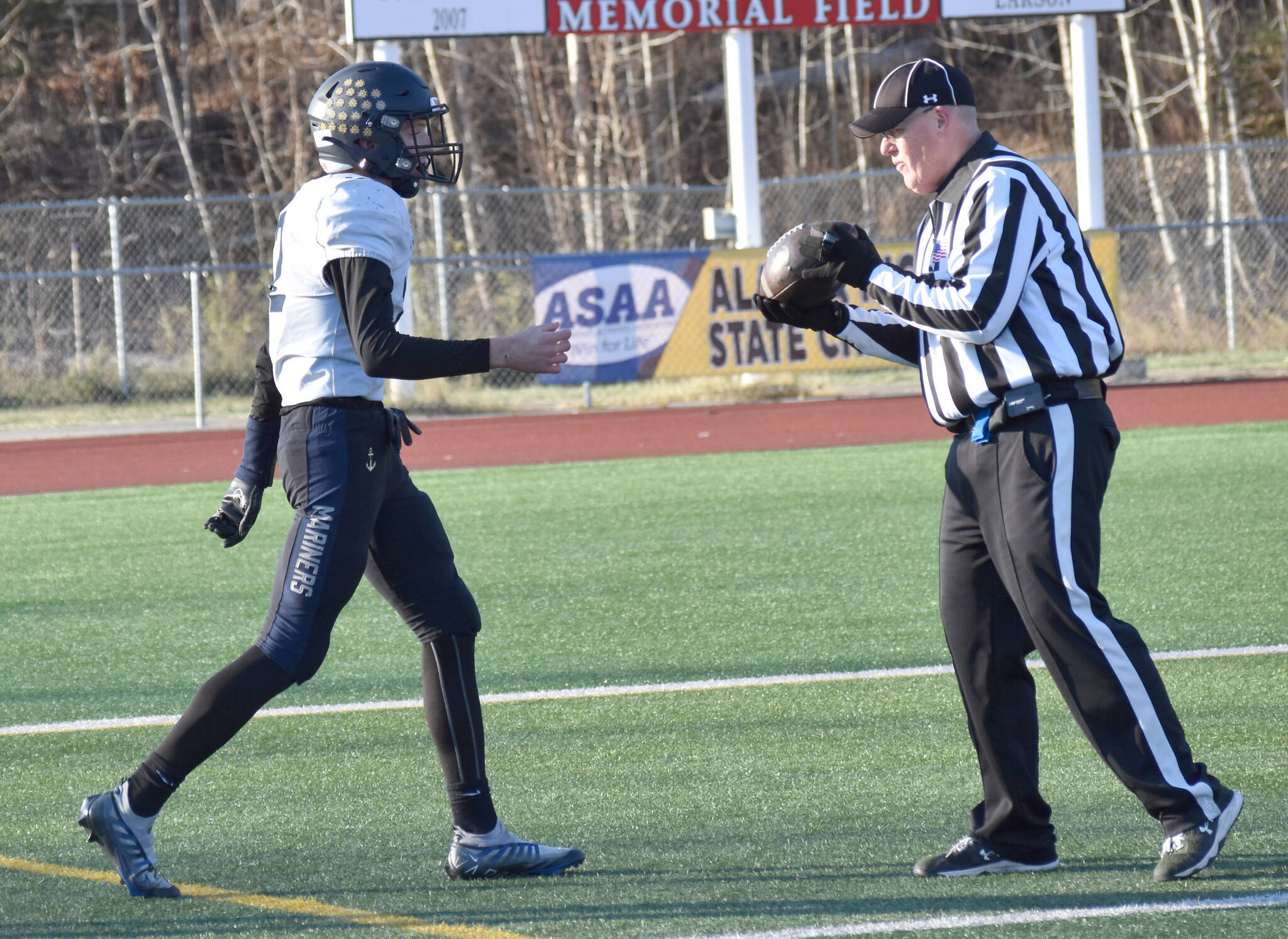 Homer’s CJ Burns hands the ball to the official after scoring the first touchdown of the game Saturday, Oct. 19, 2024, in the Division III First National Bowl at Veterans Memorial Field at Wasilla High School in Wasilla, Alaska. (Photo by Jeff Helminiak/Peninsula Clarion)