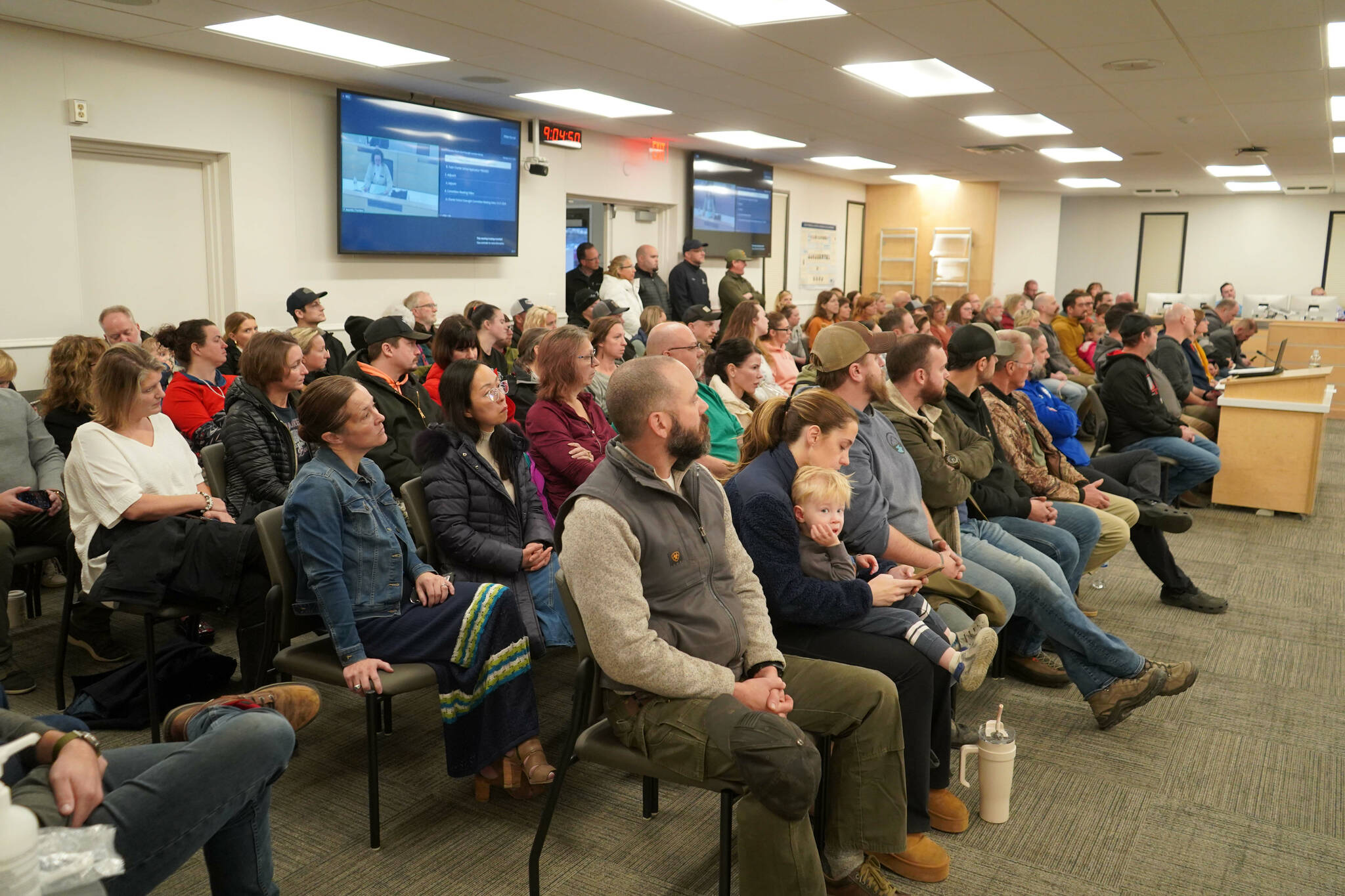 Parents and supporters of Aurora Borealis Charter School fill the Betty J. Glick Assembly Chambers during a meeting of the Kenai Peninsula Borough School District Charter Oversight Committee in Soldotna, Alaska, on Monday, Oct. 21, 2024. (Jake Dye/Peninsula Clarion)