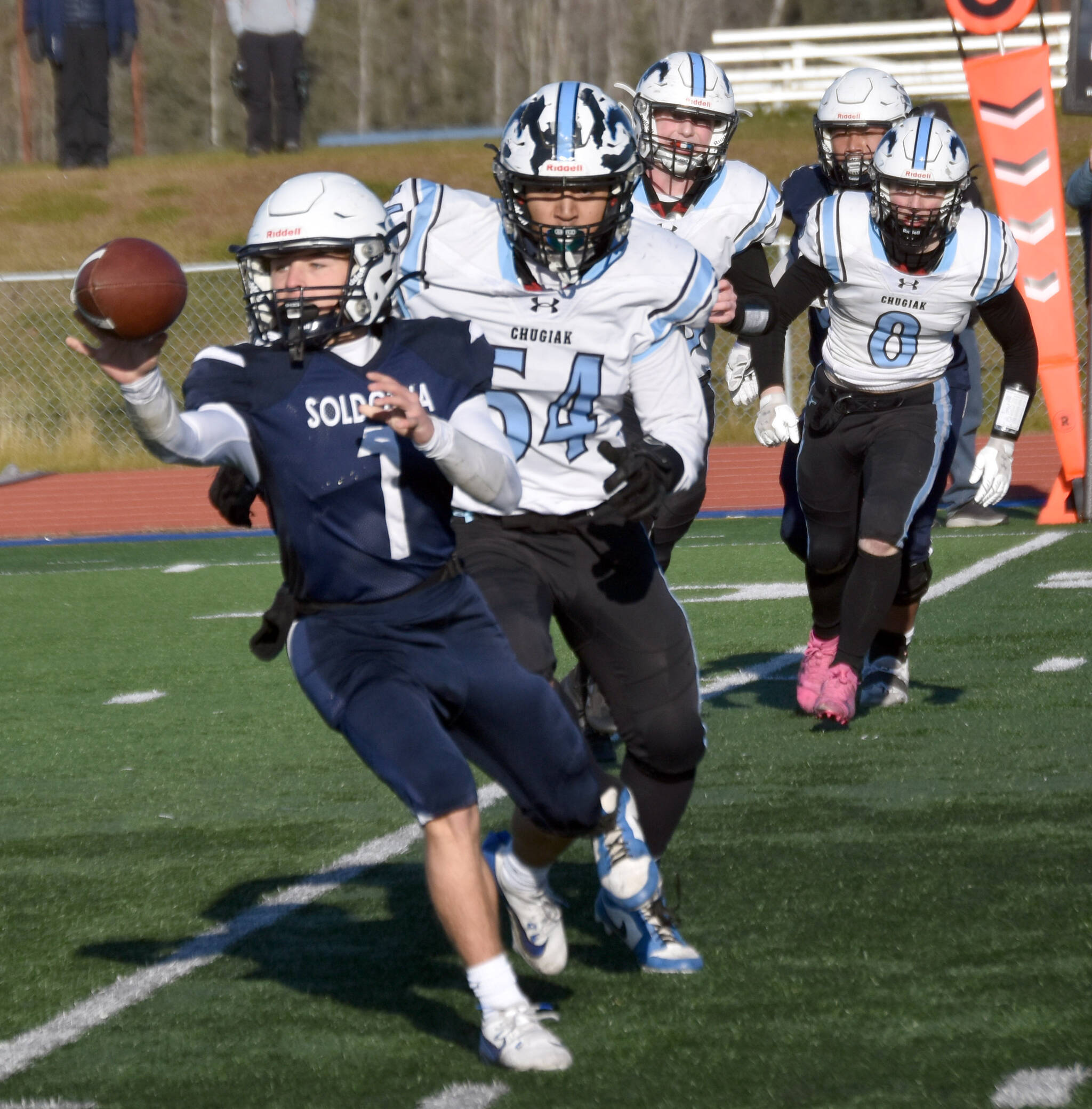 Soldotna’s Owen Buckbee pitches the ball in front of Chugiak’s Elijah Ortega in the Division II semifinal Saturday, Oct. 19, 2024, at Justin Maile Field at Soldotna High School in Soldotna, Alaska. (Photo by Jeff Helminiak/Peninsula Clarion)