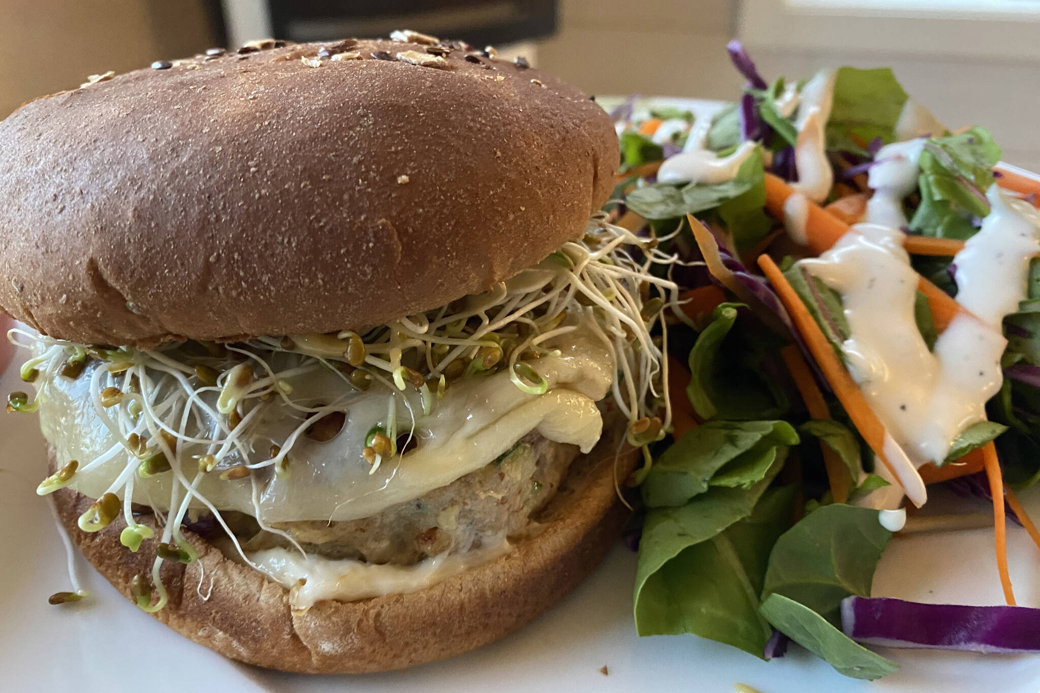 These lean turkey burgers are juicy and flavorful and go great with salad and soda. (Photo by Tressa Dale/Peninsula Clarion)