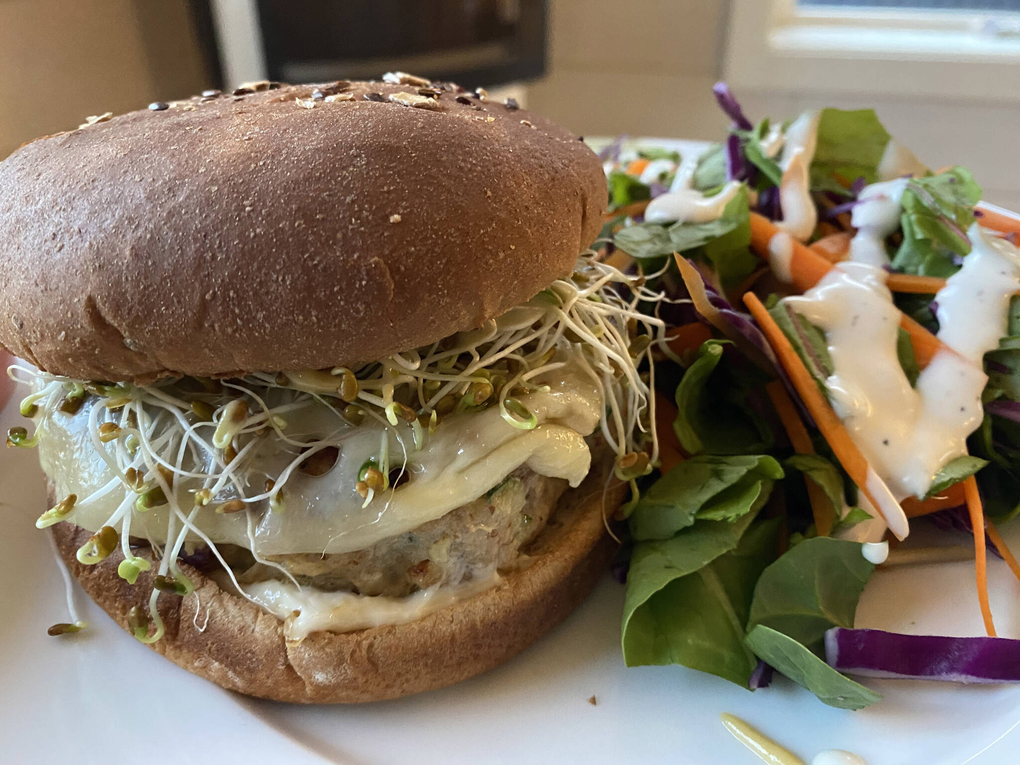 These lean turkey burgers are juicy and flavorful and go great with salad and soda. (Photo by Tressa Dale/Peninsula Clarion)