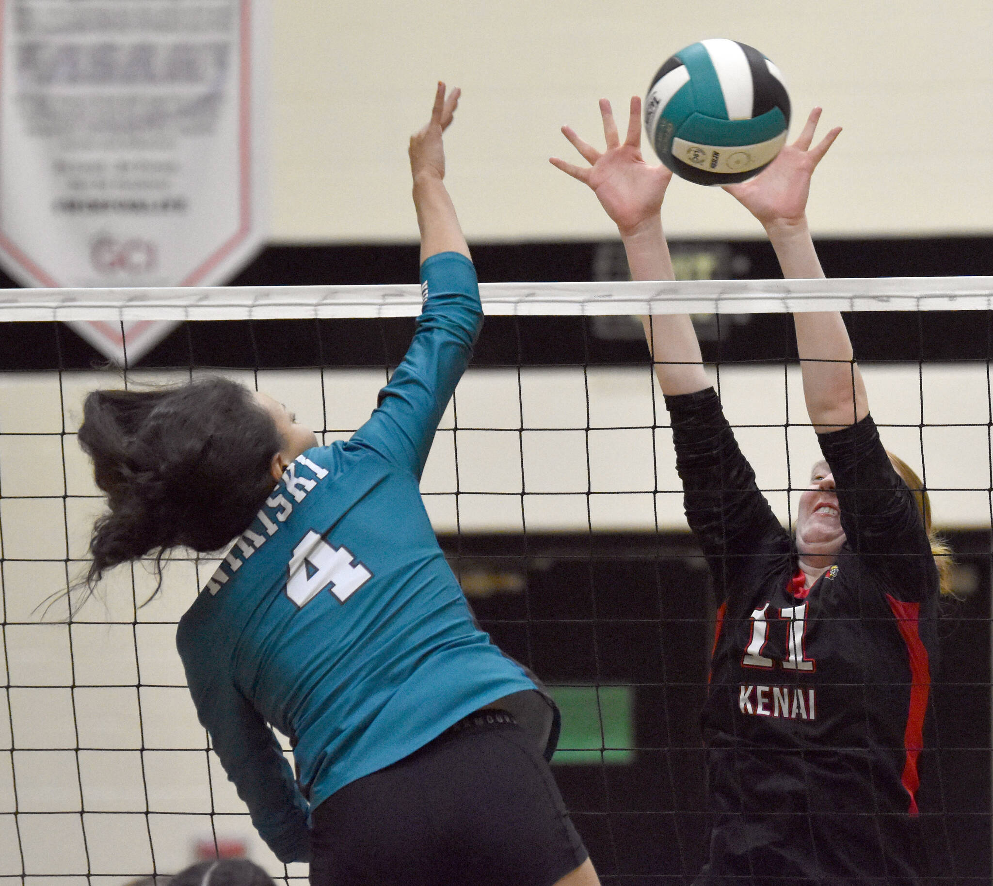 Nikiski’s Alexa Iyatunguk attacks against Kenai Central’s Ellsi Miller on Tuesday, Oct. 22, 2024, at Nikiski Middle-High School in Nikiski, Alaska. (Photo by Jeff Helminiak/Peninsula Clarion)