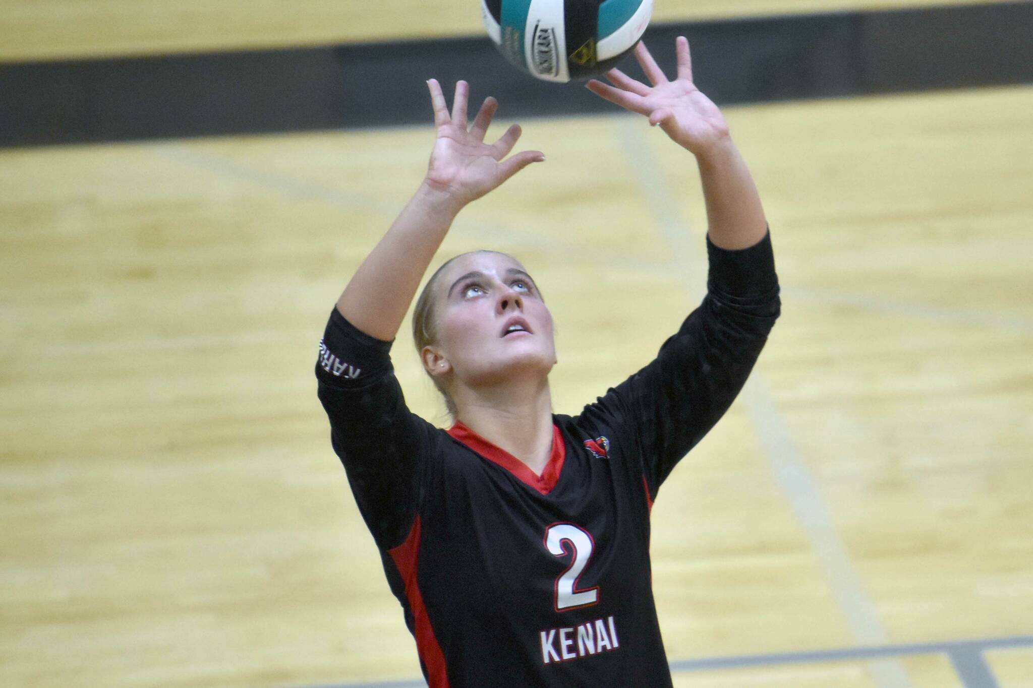 Kenai Central's Kate Wisnewski sets against Nikiski on Tuesday, Oct. 22, 2024, at Nikiski Middle-High School in Nikiski, Alaska. (Photo by Jeff Helminiak/Peninsula Clarion)