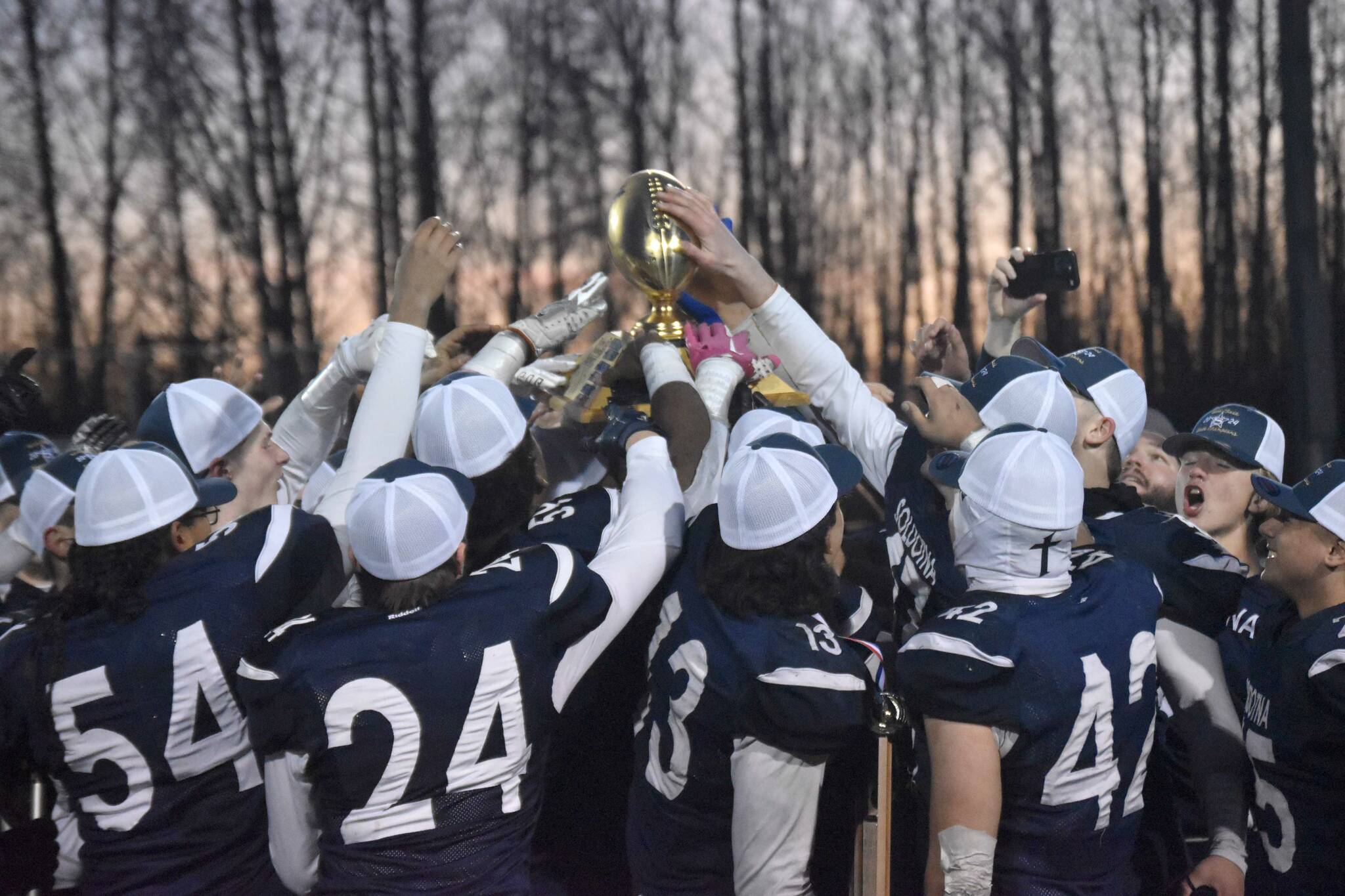 Soldotna celebrates with the trophy Saturday, Oct. 26, 2024, at the First National Bowl Division II title game at Pride Field at Colony High School in Palmer, Alaska. (Photo by Jeff Helminiak/Peninsula Clarion)