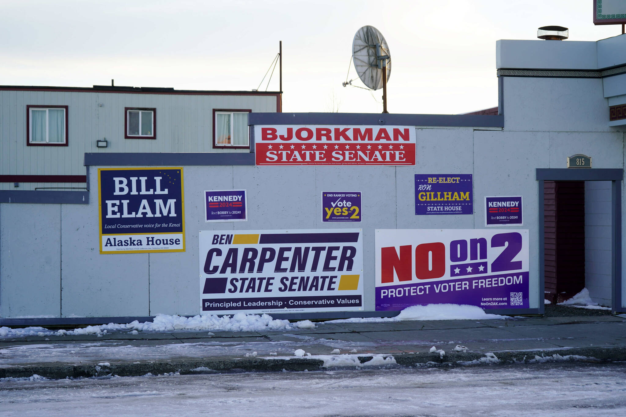 Campaign signs fill a wall near Paradisos Restaurant in Kenai, Alaska, on Wednesday, Oct. 30, 2024. (Jake Dye/Peninsula Clarion)