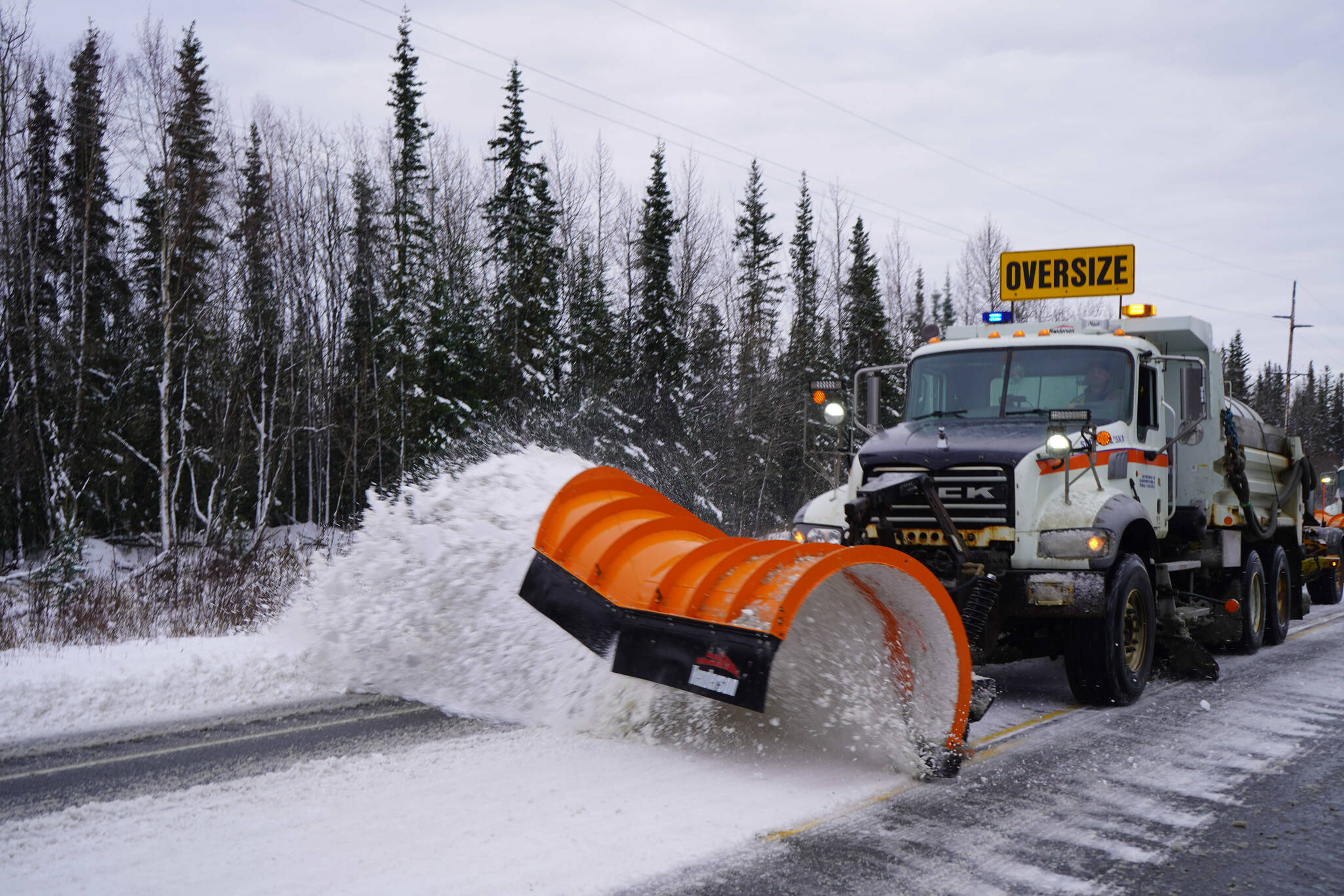 A plow truck clears snow from the Sterling Highway near Soldotna, Alaska, on Tuesday, Oct. 29, 2024. (Jake Dye/Peninsula Clarion)