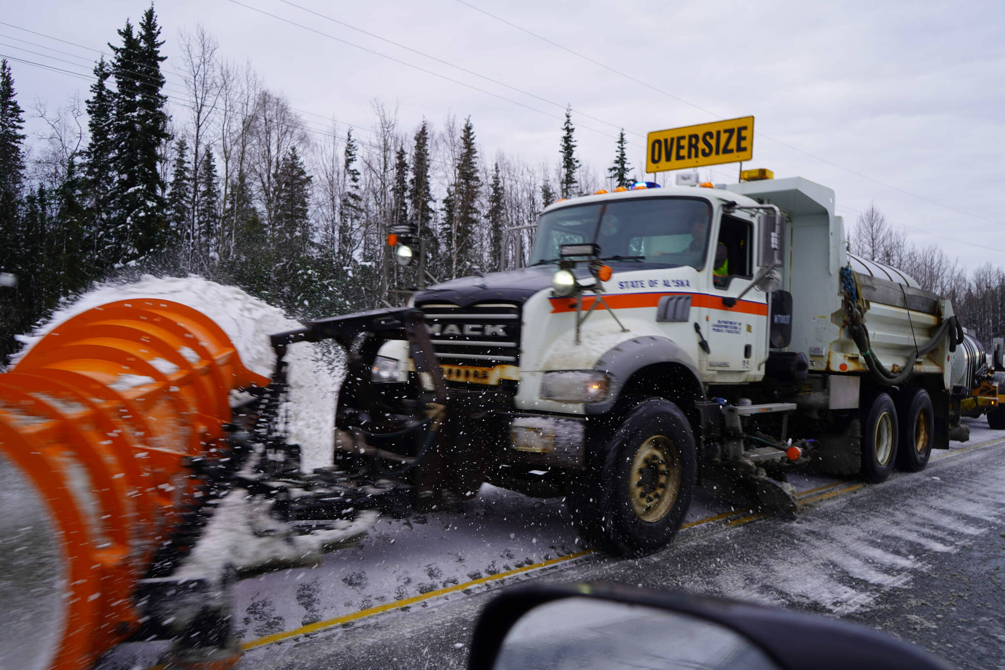 A plow truck clears snow from the Sterling Highway near Soldotna, Alaska, on Tuesday, Oct. 29, 2024. (Jake Dye/Peninsula Clarion)