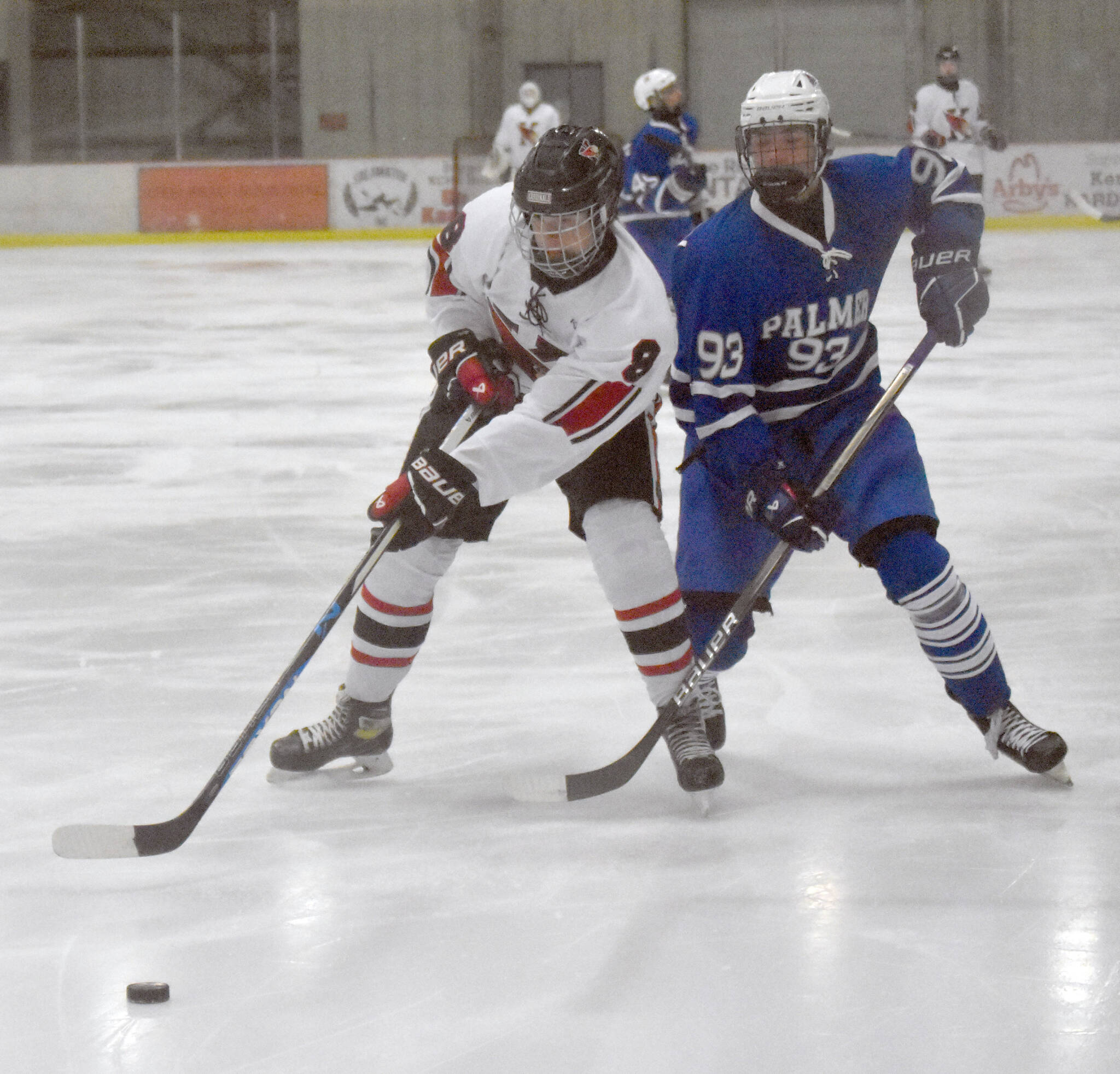 Kenai Central’s Everett Chamberlain and Palmer’s Kaleb Von Gunten battle for the puck during the Peninsula Ice Challenge on Thursday, Oct. 31, 2024, at the Kenai Multi-Purpose Facility in Kenai, Alaska. (Photo by Jeff Helminiak/Peninsula Clarion)