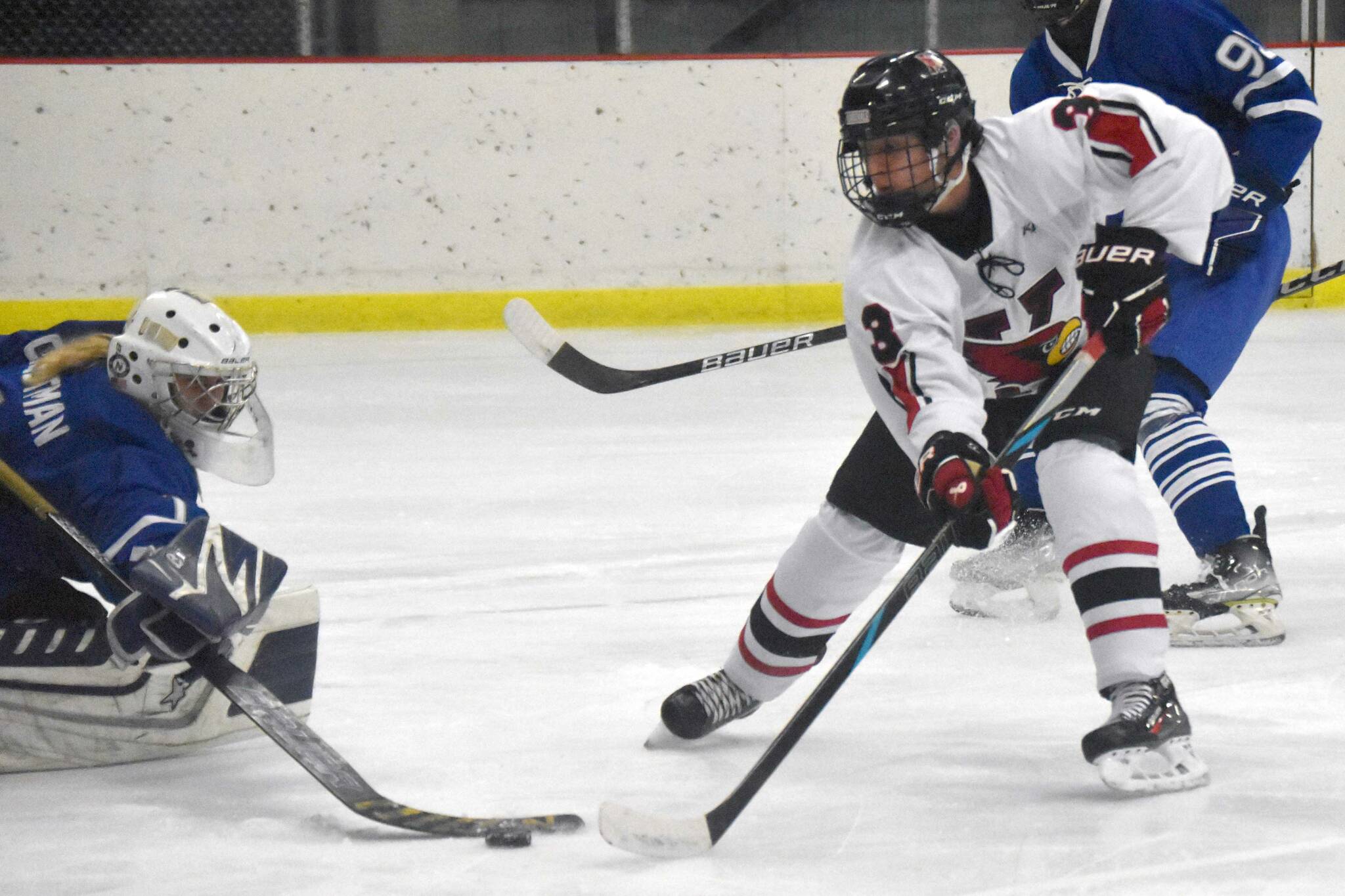 Kenai Central's Logan Mese scores on Palmer's Mily Christman during the Peninsula Ice Challenge on Thursday, Oct. 31, 2024, at the Kenai Multi-Purpose Facility in Kenai, Alaska. (Photo by Jeff Helminiak/Peninsula Clarion)