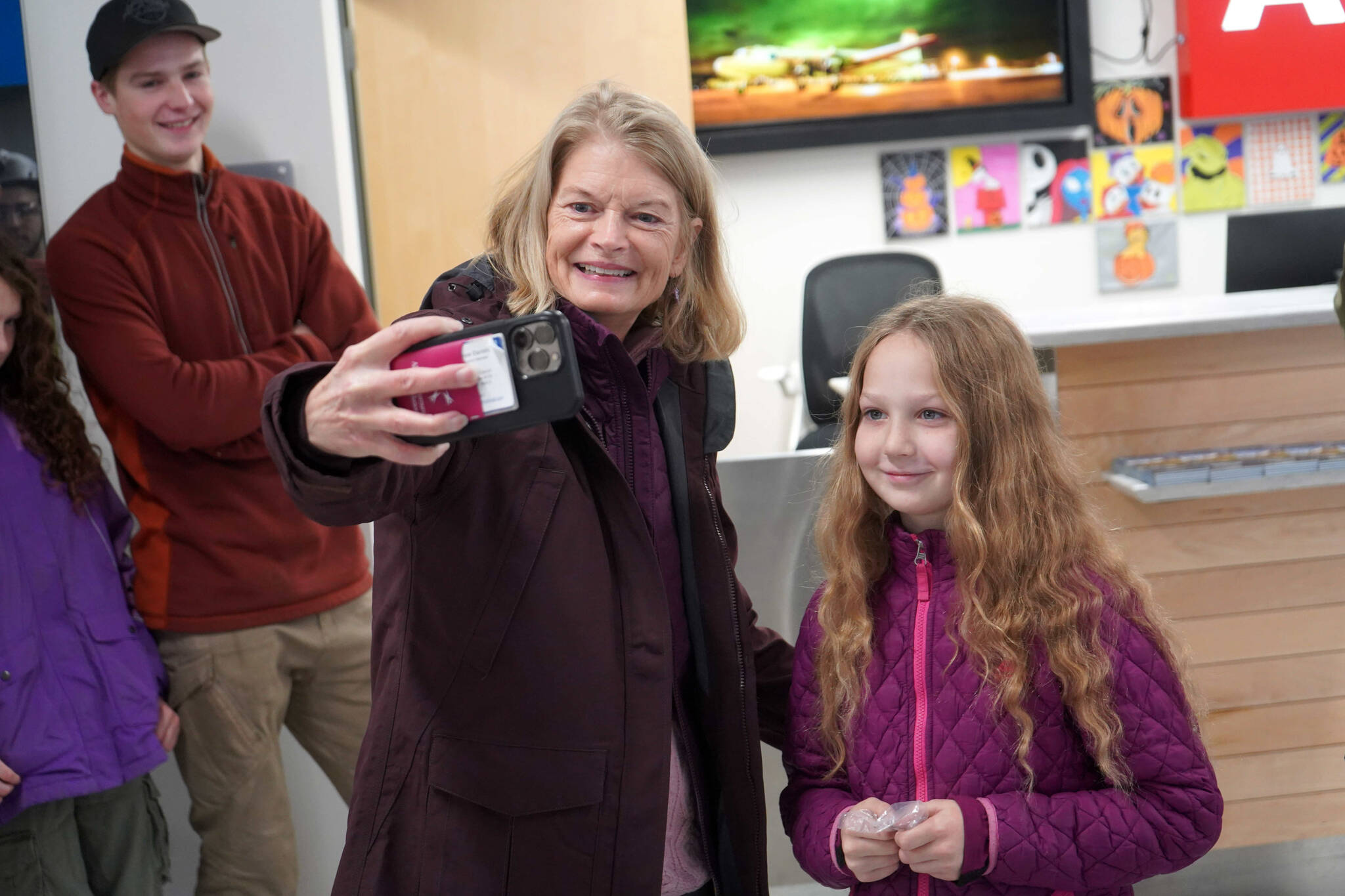 U.S. Senator Lisa Murkowski takes a selfie with Rose Burke at the Kenai Municipal Airport in Kenai, Alaska, on Friday, Nov. 1, 2024. Burke won the 2024 U.S. Capitol Christmas Tree essay contest and will travel to Washington, D.C., in December to light the tree. (Jake Dye/Peninsula Clarion)