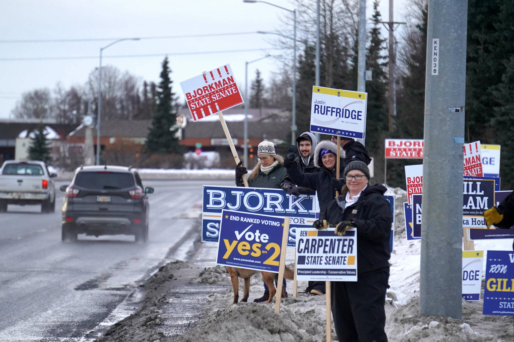 Signs and supporters line the Kenai Spur Highway in Kenai, Alaska, on Tuesday, Nov. 5, 2024. (Jake Dye/Peninsula Clarion)