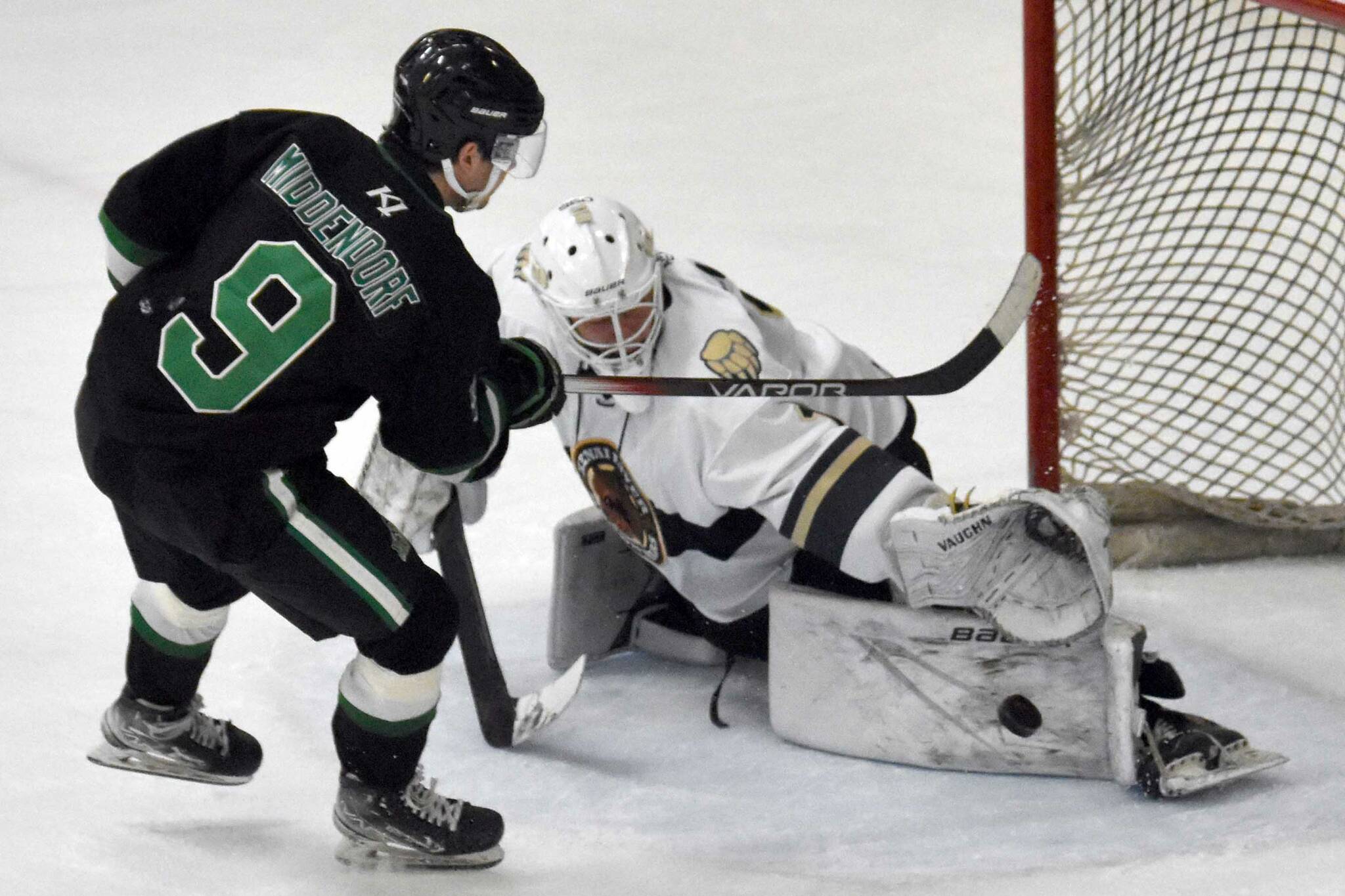 Kenai River Brown Bears goalie Mitchell Mccusker makes a save on Gavin Middendorf of the Chippewa (Wisconsin) Steel on Thursday, Nov. 7, 2024, at the Soldotna Regional Sports Complex in Soldotna, Alaska. (Photo by Jeff Helminiak/Peninsula Clarion)