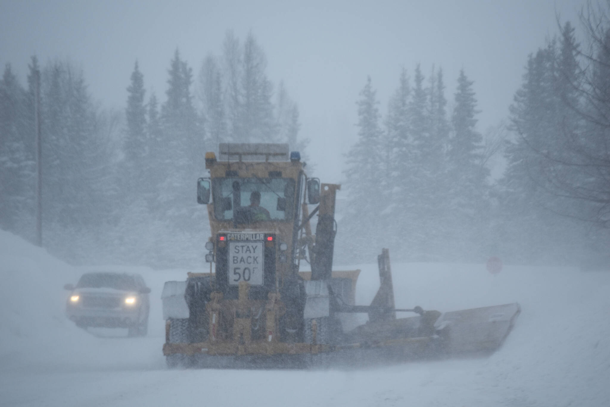 A grader moves down 1st Avenue in Kenai, Alaska, during a snow storm on Tuesday, Feb. 28, 2023. (Jake Dye/Peninsula Clarion)