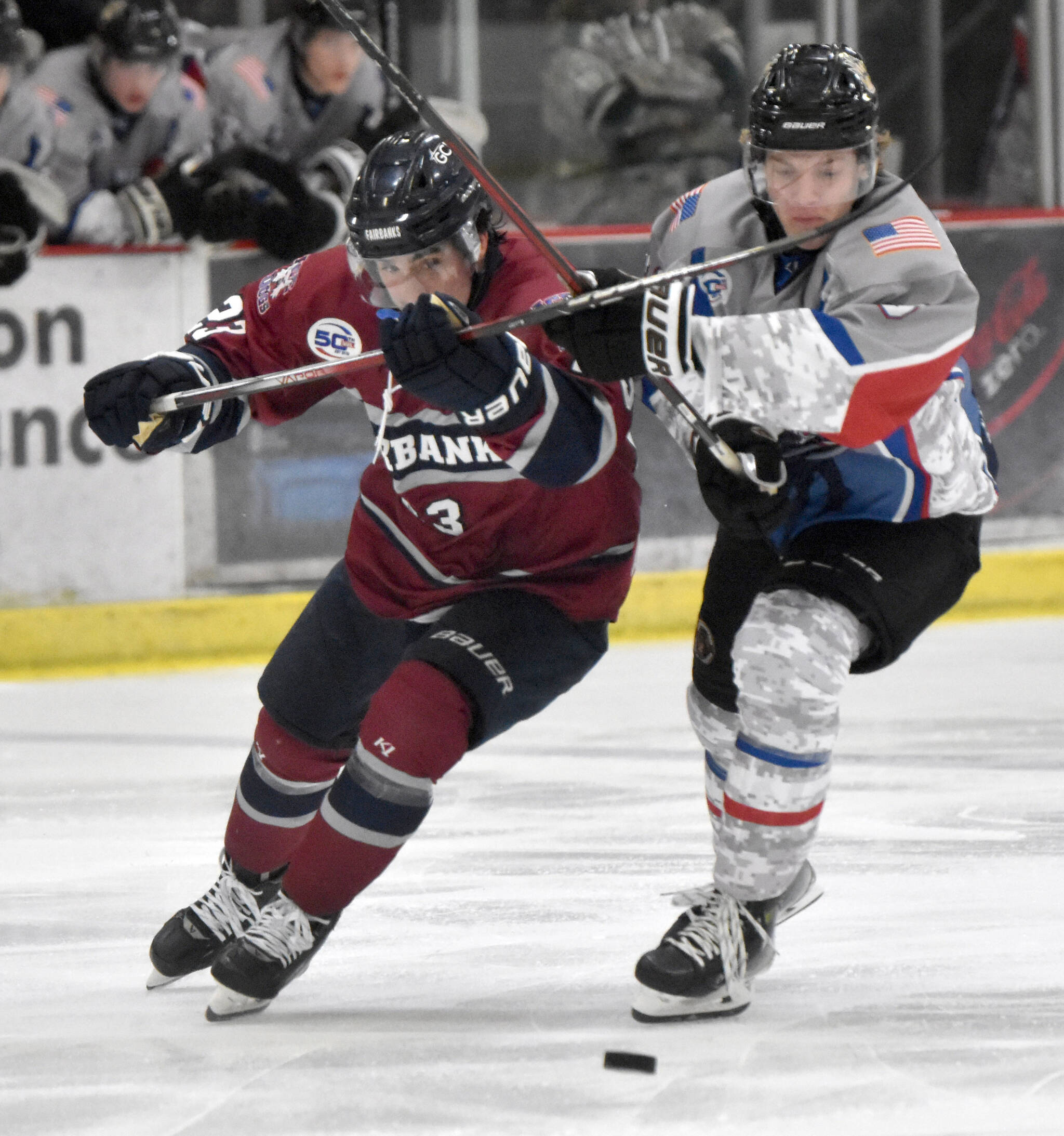 Brendan Gillmore of the Fairbanks Ice Dogs and Brady Engelkes of the Kenai River Brown Bears battle for the puck Friday, Nov. 15, 2024, at the Soldotna Regional Sports Complex in Soldotna, Alaska. (Photo by Jeff Helminiak/Peninsula Clarion)