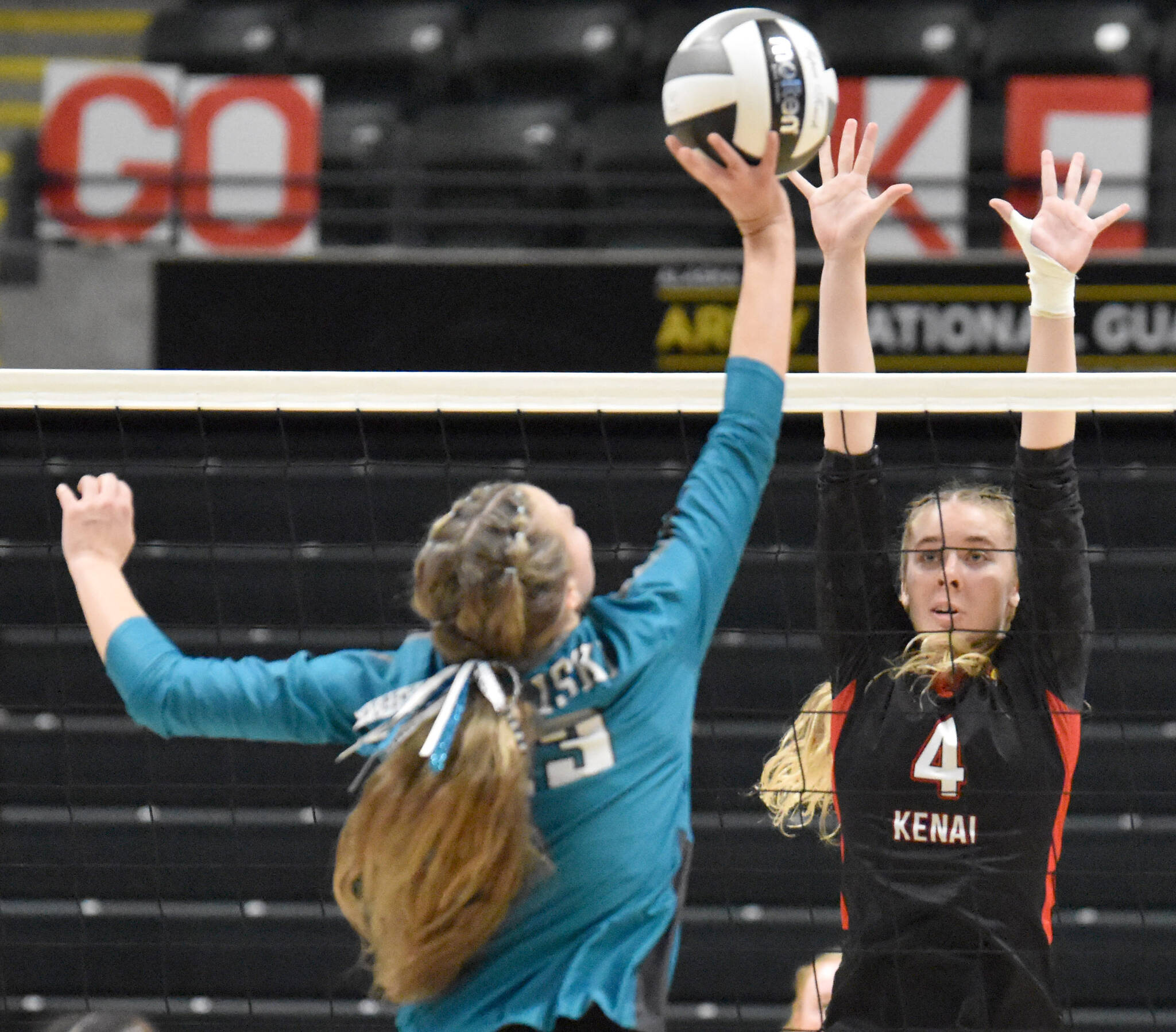 Kenai Central’s Avia Miller puts up a block on Nikiski’s Mandee Roofe on Saturday, Nov. 16, 2024, in the Class 3A state volleyball championship at the Alaska Airlines Center in Anchorage, Alaska. (Photo by Jeff Helminiak/Peninsula Clarion)