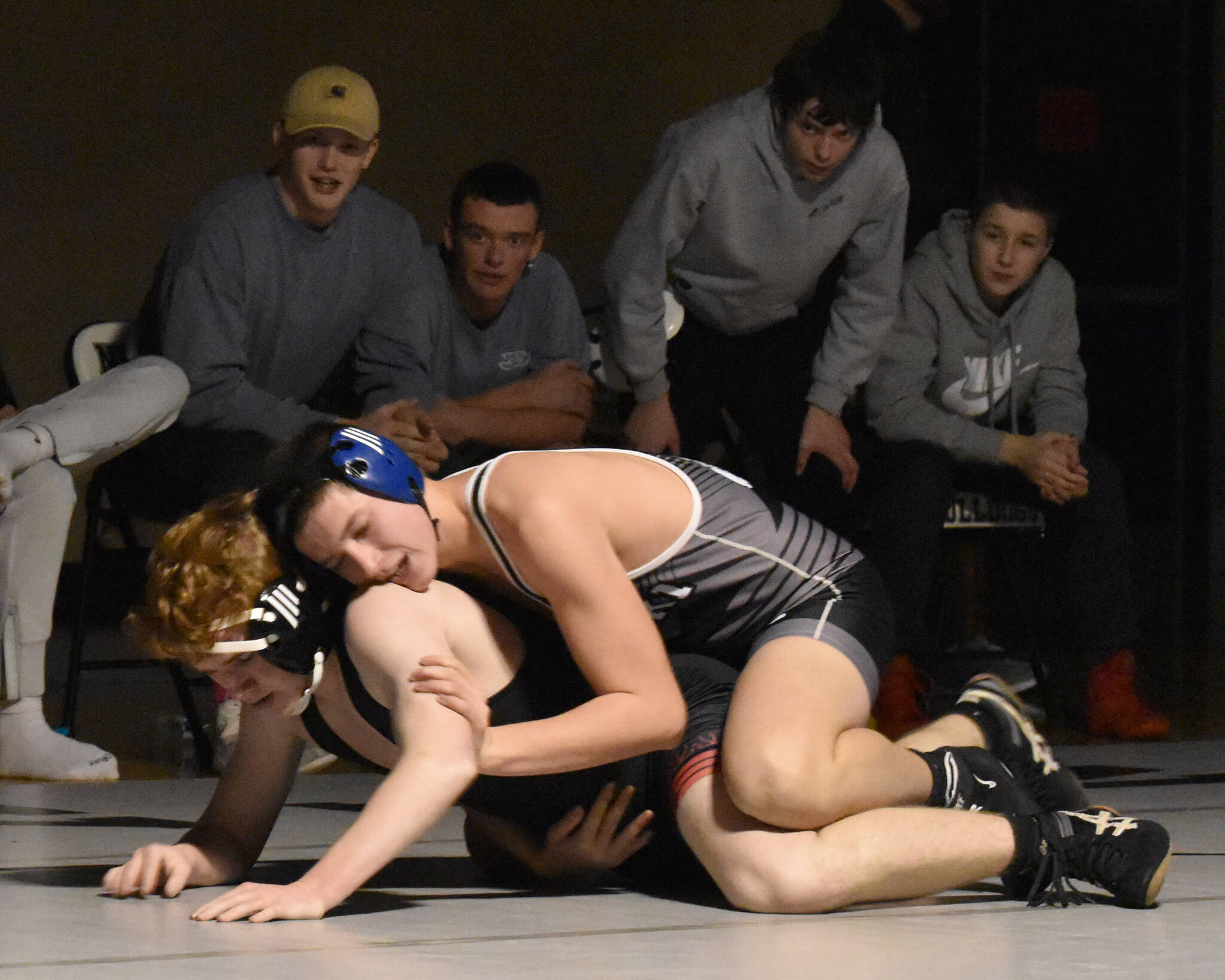 Nikiski’s Mason Doth works his way to a pin of Kenai Central’s Leighton Wilshusen on Tuesday, Nov. 26, 2024, at Nikiski Middle-High School in Nikiski, Alaska. (Photo by Jeff Helminiak/Peninsula Clarion)