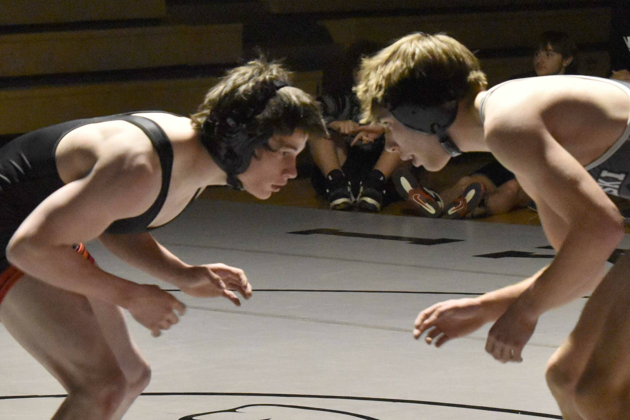 Nikiski's Wyatt Maguire works his way to a pin of Kenai Central's Conner Cook on Tuesday, Nov. 26, 2024, at Nikiski Middle-High School in Nikiski, Alaska. (Photo by Jeff Helminiak/Peninsula Clarion)