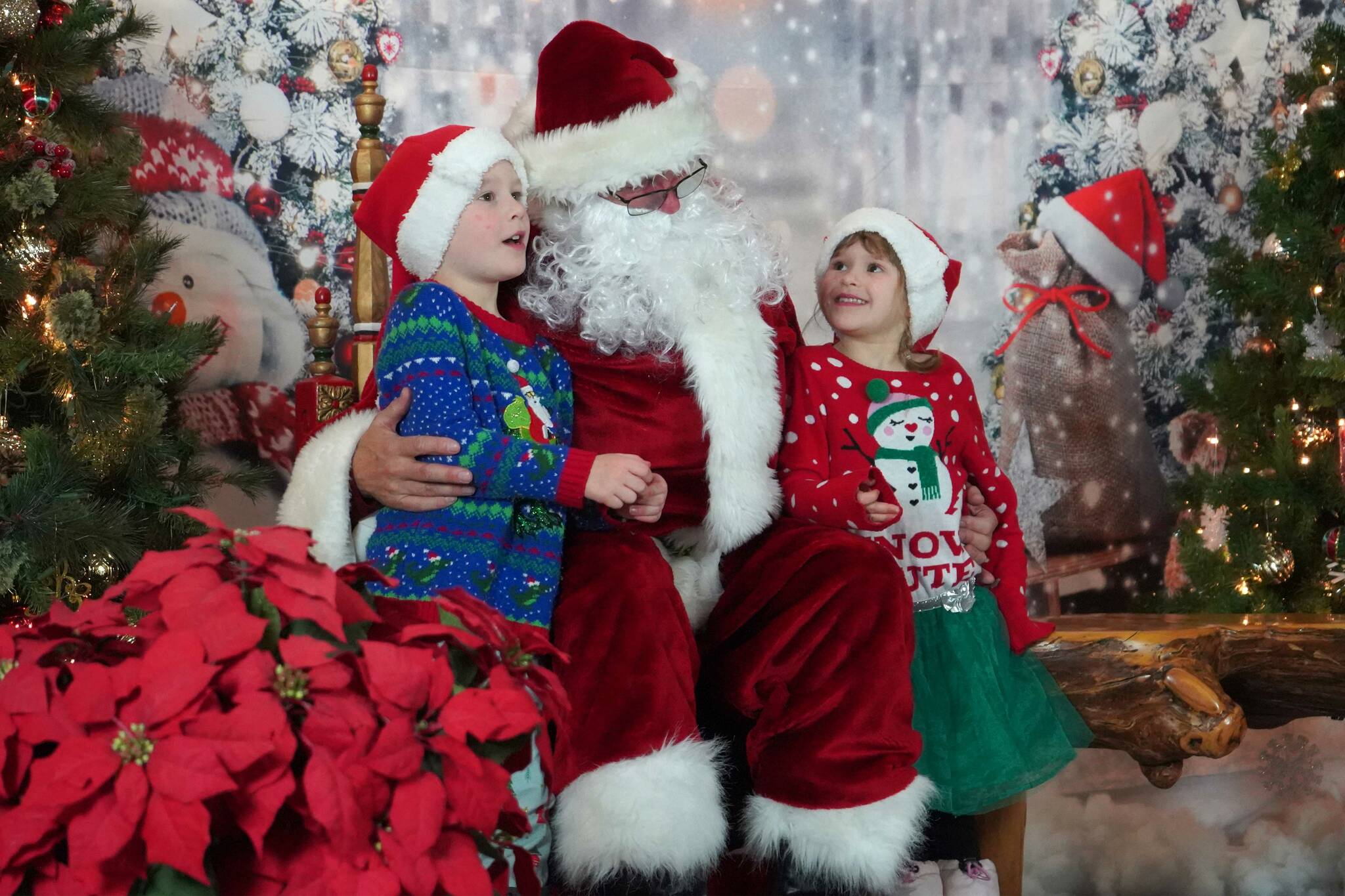 Jace and Tali Kimmel share their Christmas wishes with Santa Claus during Christmas Comes to Kenai at the Kenai Chamber of Commerce and Visitor Center in Kenai, Alaska, on Friday, Nov. 29, 2024. (Jake Dye/Peninsula Clarion)