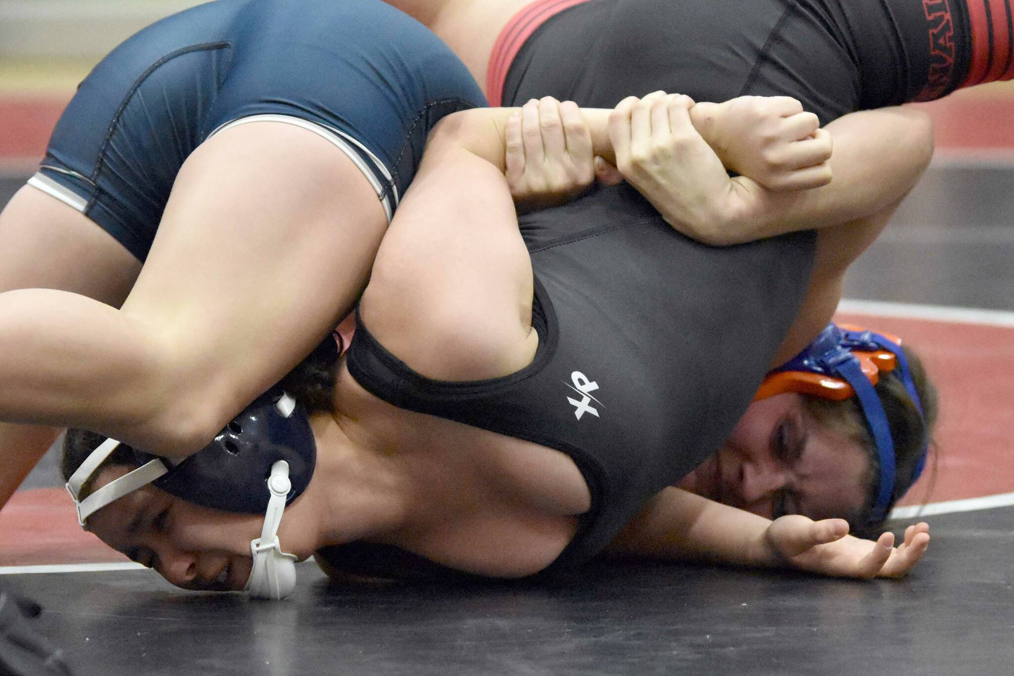 Kenai Central's Jadeyn Jacko and Soldotna's Mia Hannevold wrestle Tuesday, Dec. 4, 2024, at Kenai Central High School in Kenai, Alaska. (Photo by Jeff Helminiak/Peninsula Clarion)