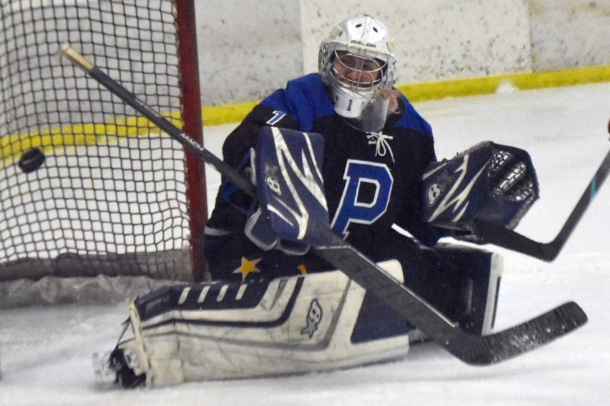 Palmer goalie Mily Christman makes a save Saturday, Dec. 7, 2024, at the Kenai Multi-Purpose Facility in Kenai, Alaska. (Photo by Jeff Helminiak/Peninsula Clarion)