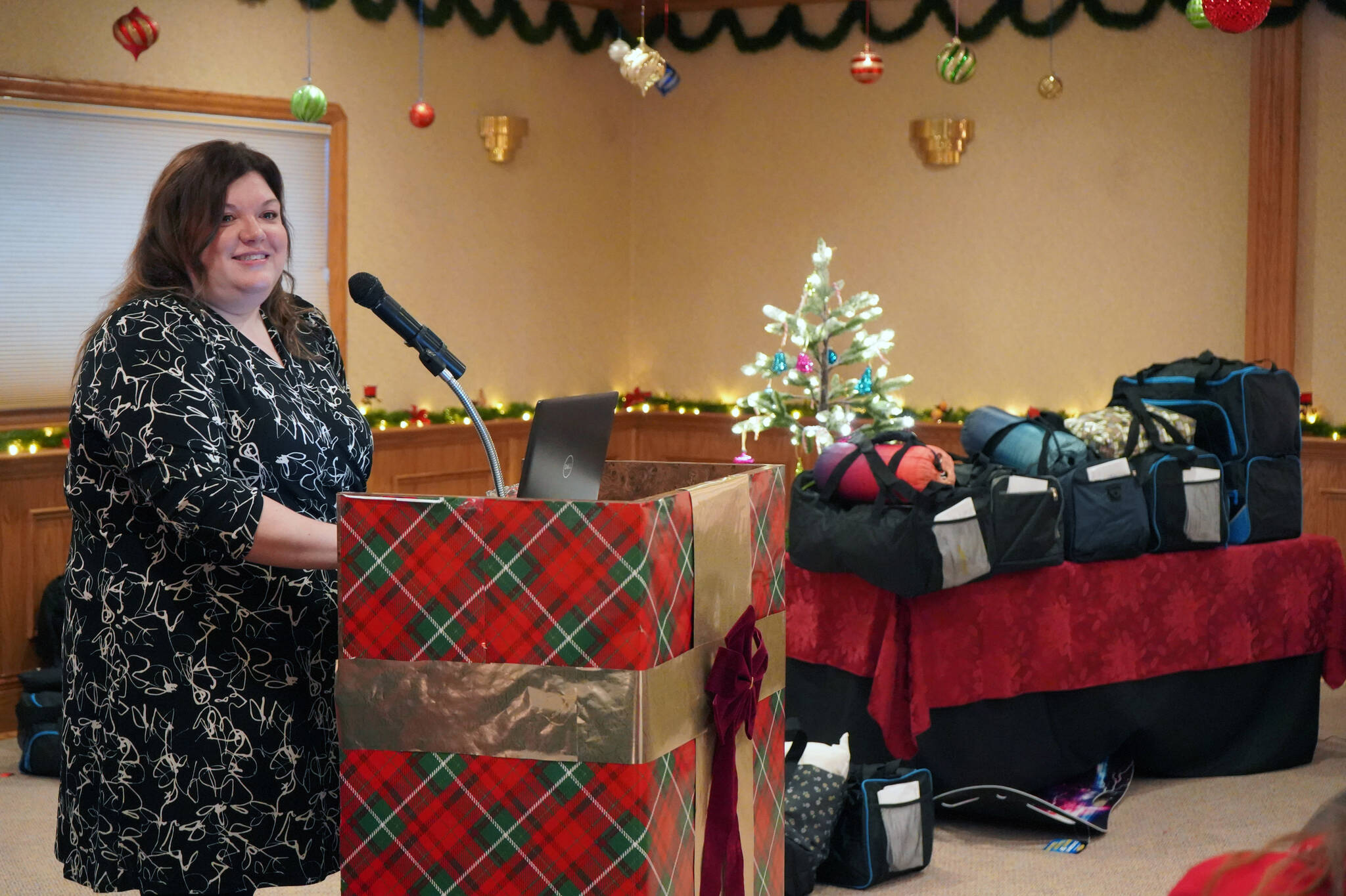 Kelly King speaks to the Kenai Peninsula Association of Realtors on behalf of the Kenai Peninsula Borough School District’s Students in Transition at Kenai Catering on Thursday, Dec. 14, 2023. (Jake Dye/Peninsula Clarion)