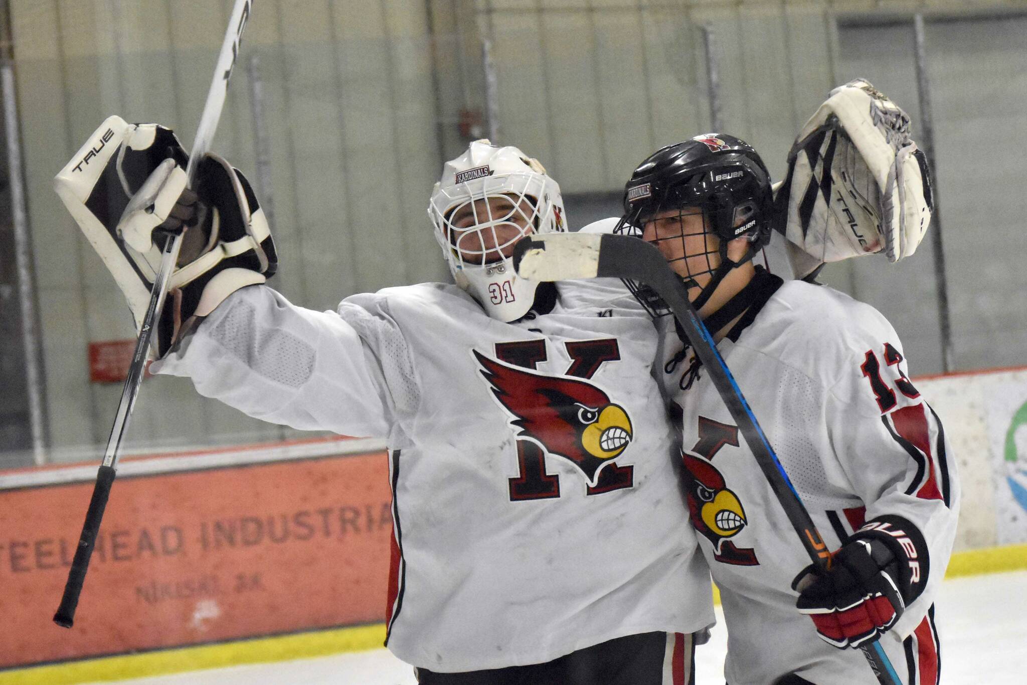 Kenai Central goalie Evyn Witt and William Howard celebrate a victory over Soldotna on Tuesday, Dec. 17, 2024, at the Kenai Multi-Purpose Facility in Kenai, Alaska. (Photo by Jeff Helminiak/Peninsula Clarion)