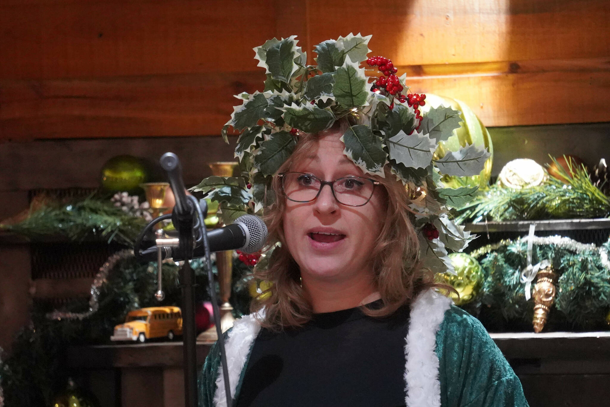 AnnMarie Rudstrom, dressed as the Ghost of Christmas Present, reads Charles Dickens’ “A Christmas Carol” at The Goods in Soldotna, Alaska, on Thursday, Dec. 19, 2024. (Jake Dye/Peninsula Clarion)