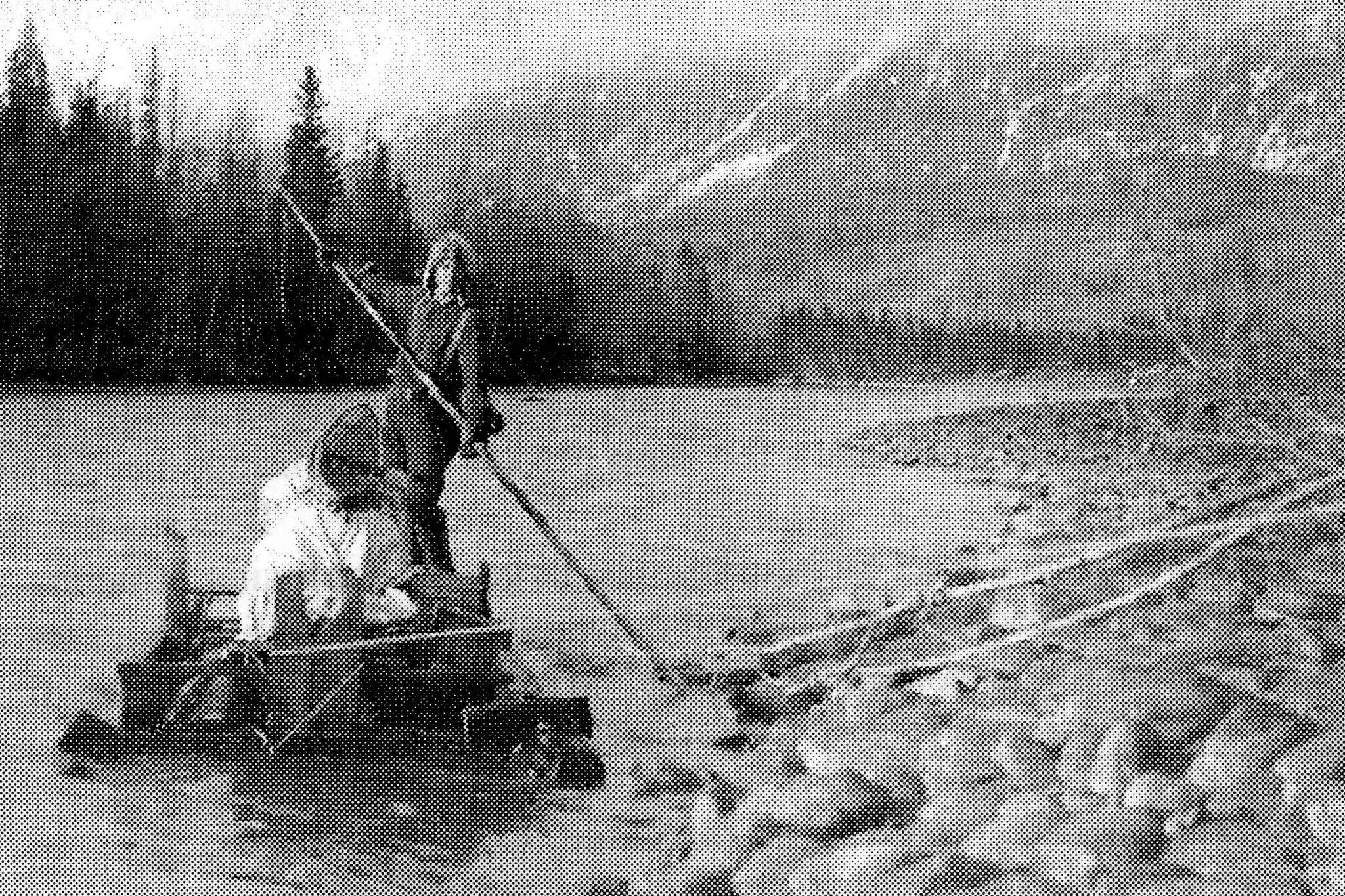 Keith McCullagh is photographed poling a raft down the Kenai River in 1911 during a forest survey. (U.S. Forestry Department photo by John “Jack” Brown)