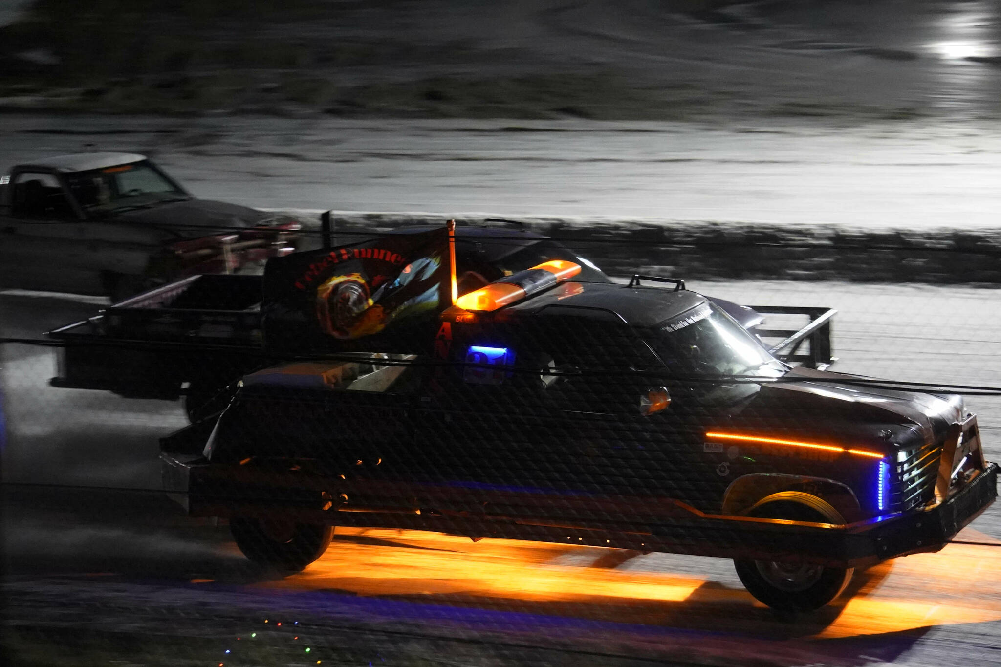 Racers vie for the lead in the first race of the Kenai Peninsula Ice Racing season at Twin City Raceway in Kenai, Alaska, on Tuesday, Dec. 31, 2024. (Jake Dye/Peninsula Clarion)