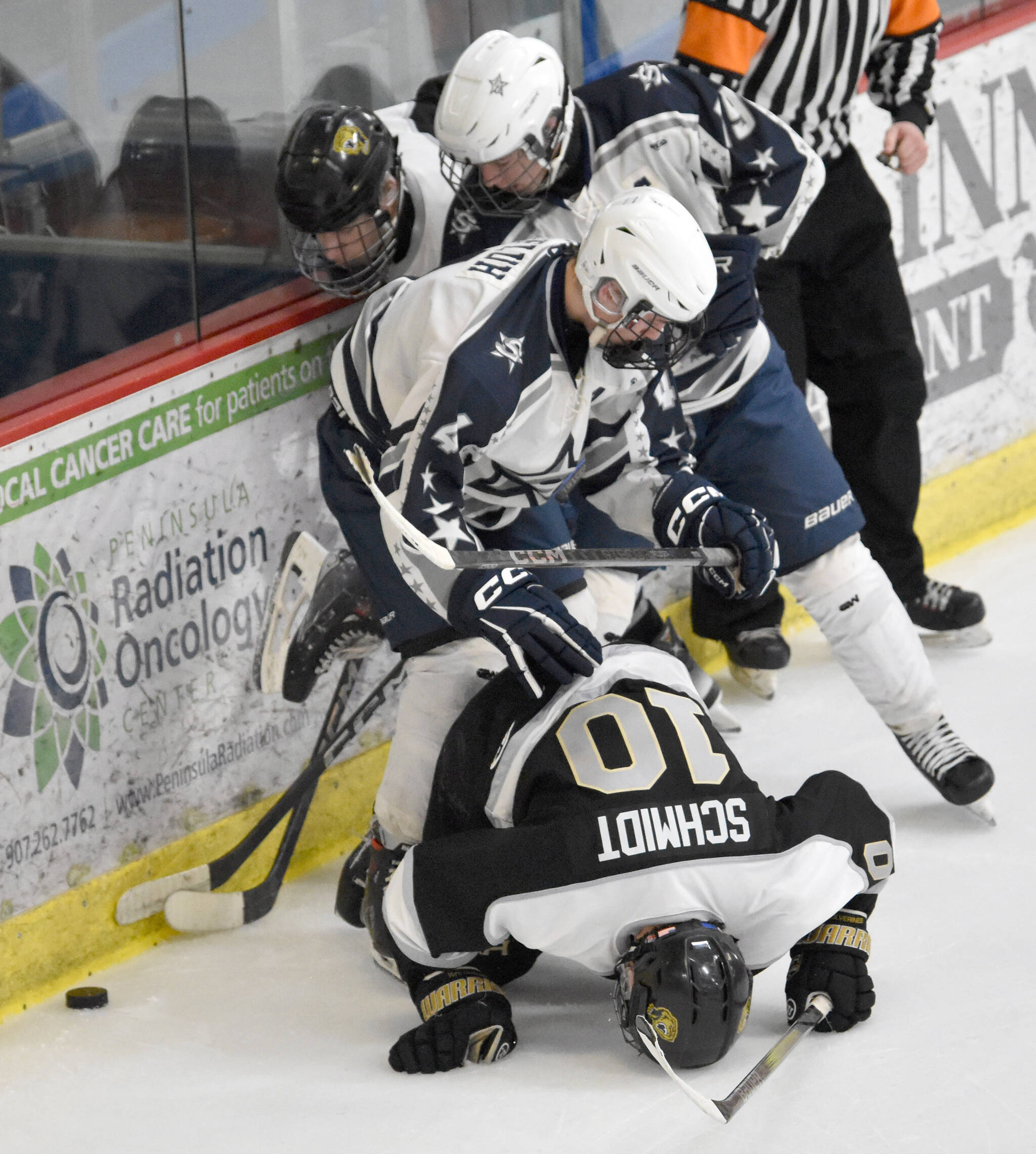 South’s Carson Lake and Vance Schmidt and Soldotna’s Marshall DeRaeve and Zack Zurfluh battle for the puck Friday, Jan. 10, 2025, at the Soldotna Regional Sports Complex in Soldotna, Alaska. (Photo by Jeff Helminiak/Peninsula Clarion)