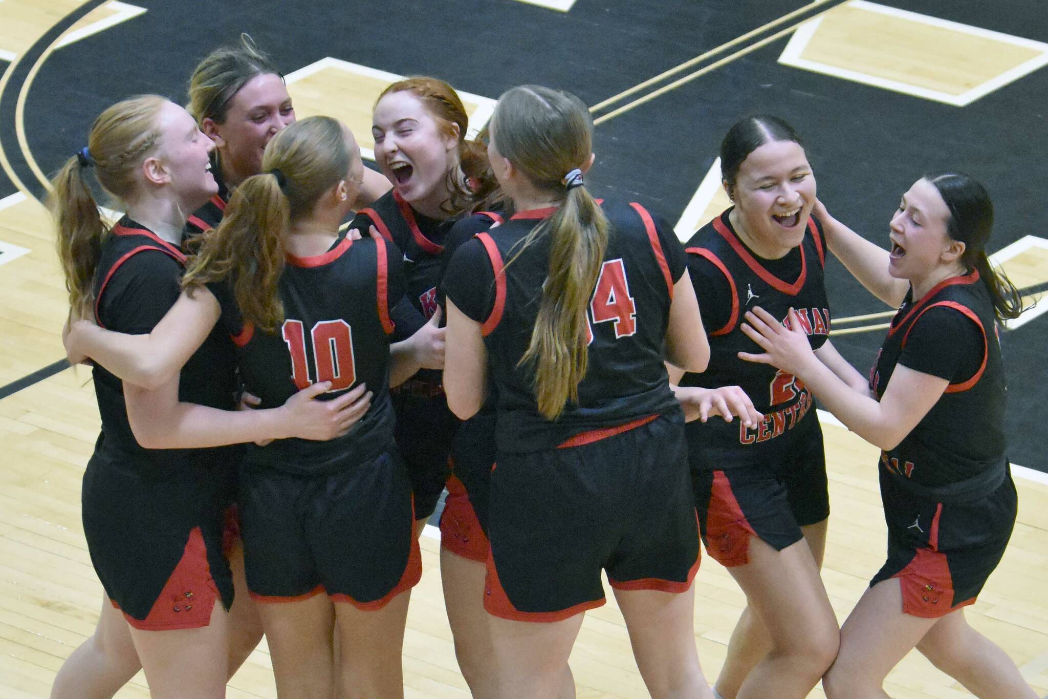 The Kenai Central girls celebrate earning a Class 3A state berth Friday, March 7, 2025, at the Peninsula Conference tournament at Nikiski Middle-High School in Nikiski, Alaska. (Photo by Jeff Helminiak/Peninsula Clarion)