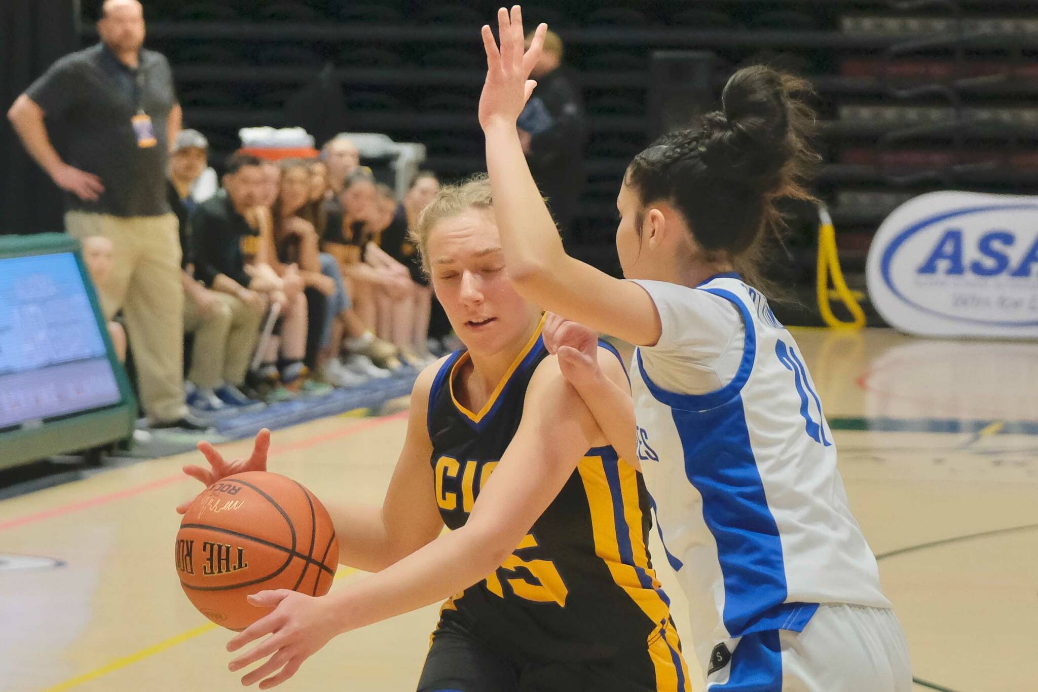 Cook Inlet Academy junior Clara Warren drives against Fort Yukon sophomore Karli Thomas during their opening game at the 2025 ASAA March Madness Alaska 1A/2A State Basketball Championships on Wednesday, March 12, 2025, at the Alaska Airlines Center in Anchorage, Alaska. (Klas Stolpe / Juneau Empire)